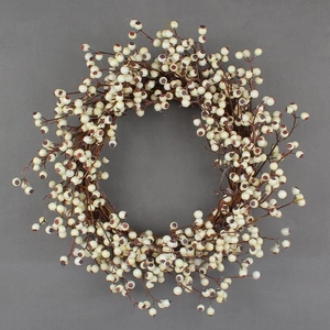 Christmas wreath with white berries and brown twigs on a neutral grey background