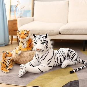 Realistic plush tiger toys in orange and white stripes resting on a cozy home carpet