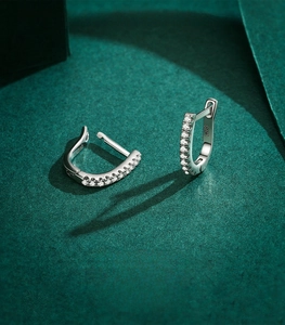 Macro shot of S925 sterling silver U-shaped hoop earrings with sparkling zircon stones