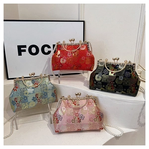 Detail view of retro brocade evening bags with floral embroidery and pearl handles