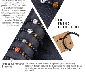Detail view of soccer bracelets with natural stones and motivational card on leather background