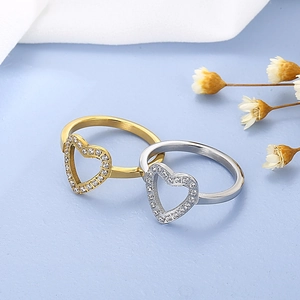 Detailed view of hollow heart rings with cubic zirconia in gold and silver finishes