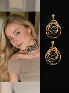 Detail of layered gold round tassel drop earrings with a stylish hollow geometric design