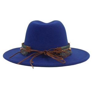 Detail of royal blue felt western hat featuring bohemian braided band and fringe accents