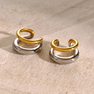 Close-up of gold and silver mixed metal C-shaped double layered hoop earrings for women