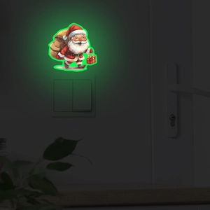 Luminous Santa Claus wall sticker showing green glow effect on a bedroom light switch