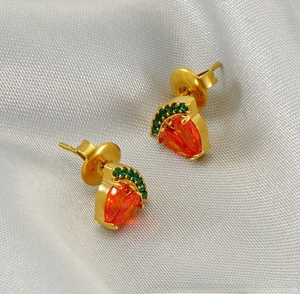 Vue détaillée des boucles d'oreilles pastèque avec zircons orange et cristaux verts