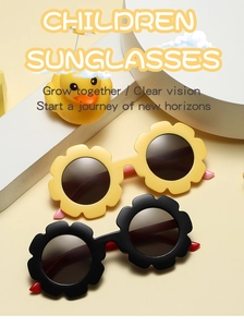 Detail of flower shaped frame children sunglasses in yellow and black with dark lenses