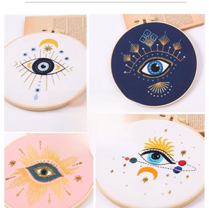 Macro shot of boho evil eye embroidery kit with celestial sun and moon patterns
