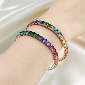 Gros plan de bracelets tennis en zircone arc-en-ciel sur fond de soie blanche
