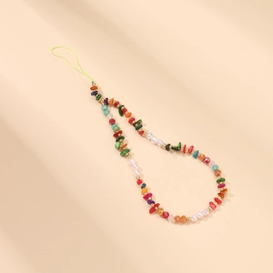 Detail of colorful beaded phone strap with vibrant stone beads and pearls on beige background