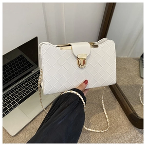 Detailed view of white woven leather handbag with gold metal clasp and chain strap