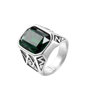 Dettaglio anello massonico con pietra verde taglio smeraldo e simbolo G in argento
