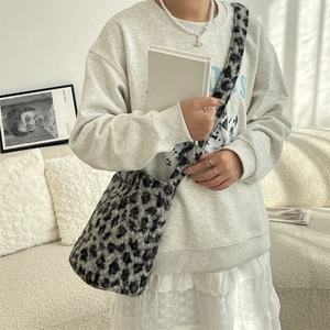 Detailed plush texture of the leopard print faux fur crossbody bucket bag