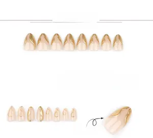Detailed view of nude pink almond press-on nails with 3D metallic gold relief lines