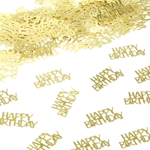 Macro shot of metallic gold Happy Birthday confetti pieces for festive table decoration