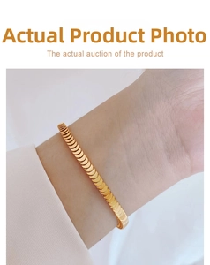 Macro detail of a 18K gold fish scale bracelet featuring a modern matte textured finish