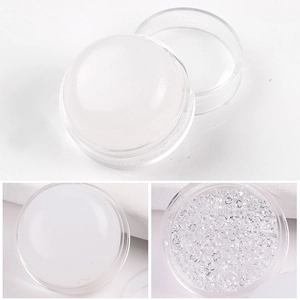 Detail view of transparent silicone nail stamper with iridescent rhinestones and clear lid