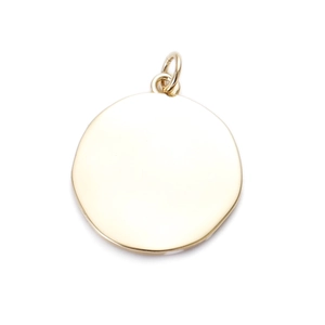 Close-up of a polished gold round metal charm pendant for DIY jewelry making