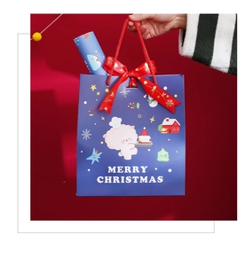 Détail du sac cadeau de Noël bleu marine avec ruban rouge et personnage de mouton