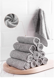 Macro view of charcoal fiber dishcloths stacked on a wooden tray for kitchen cleaning