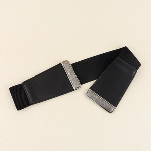 Detail of black elastic corset belt with retro silver textured metal frame on background