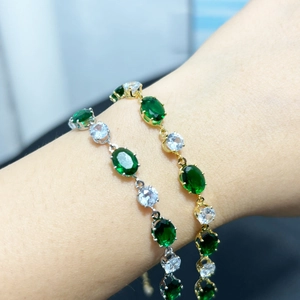 Gros plan du bracelet émeraude et zircon avec pierres ovales et rondes alternées