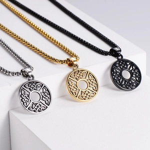 Close-up of Celtic knot round pendants in silver, gold, and black with box chain necklaces