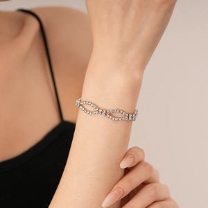 Detailed view of silver-tone zircon bracelet featuring interlocking wavy hollow design