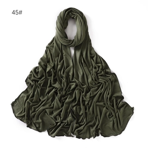 Detail view of olive green jersey scarf featuring fine overlock stitching and soft texture