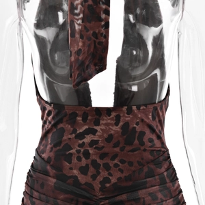 Detail view of leopard print dress featuring a backless halter neck and ruched mesh texture