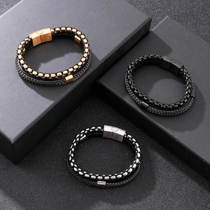 Macro detail of men's multilayer braided leather bracelets with stainless steel magnetic clasp