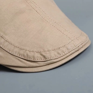 Classic beige cotton beret hat featuring fine twill texture and precision stitching