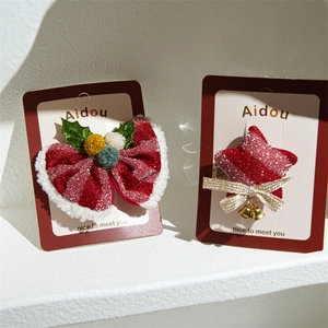 Festive red fabric star and bow hair clip set with bells for Christmas and New Year