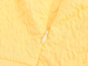 Close-up of yellow embossed bubble fabric texture and matching invisible teardrop zipper