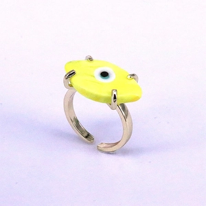 Adjustable silver ring featuring a vibrant yellow evil eye charm in a minimalist boho style