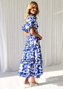 Detailed view of puff sleeves and layered tiered hem on blue and white printed dress
