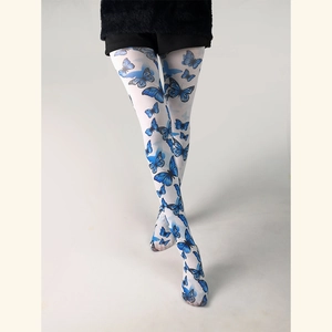 Sheer white tights with elegant blue butterfly print worn by model in studio setting