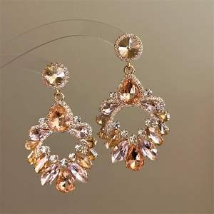 Detailed close-up of hollow water-drop tassel earrings with colorful crystal inlay