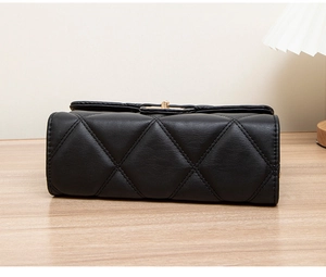 Detailed view of black quilted faux leather crossbody bag with rhombic stitching texture
