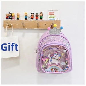 Detail of purple sequin unicorn backpack with crown and pom-pom decor on a wall hook