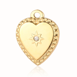 Detailed view of a gold heart pendant featuring a starburst and clear gemstone