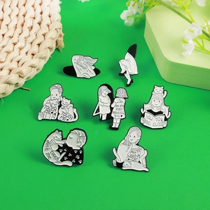 Whimsical black and white cartoon cat and boy enamel pins set for jackets and bags
