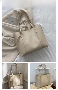 Detail view of large cream white PU leather tote bag with elegant shoulder straps