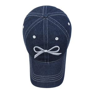 Washed denim baseball cap with bow embroidery and contrast stitching details