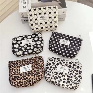 Portable corduroy cosmetic pouches in five patterns including leopard and floral prints
