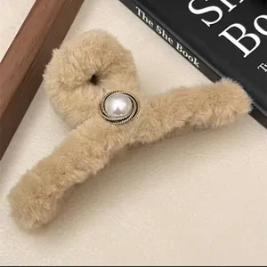 Furry light brown plush hair claw clip with a large central pearl and metal trim