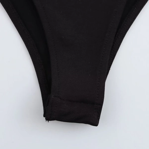 Macro shot of durable double-needle stitching on the black knit bodysuit crotch area