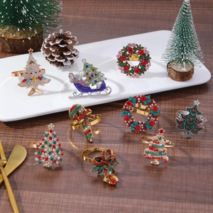 Christmas napkin rings set with colorful zircons in tree, wreath, and sled shapes