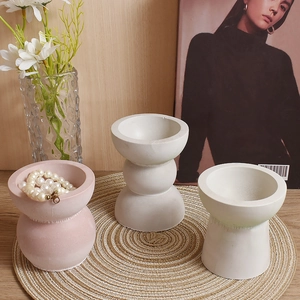 Macro detail of geometric resin candle holders with a matte finish and warm home decor style